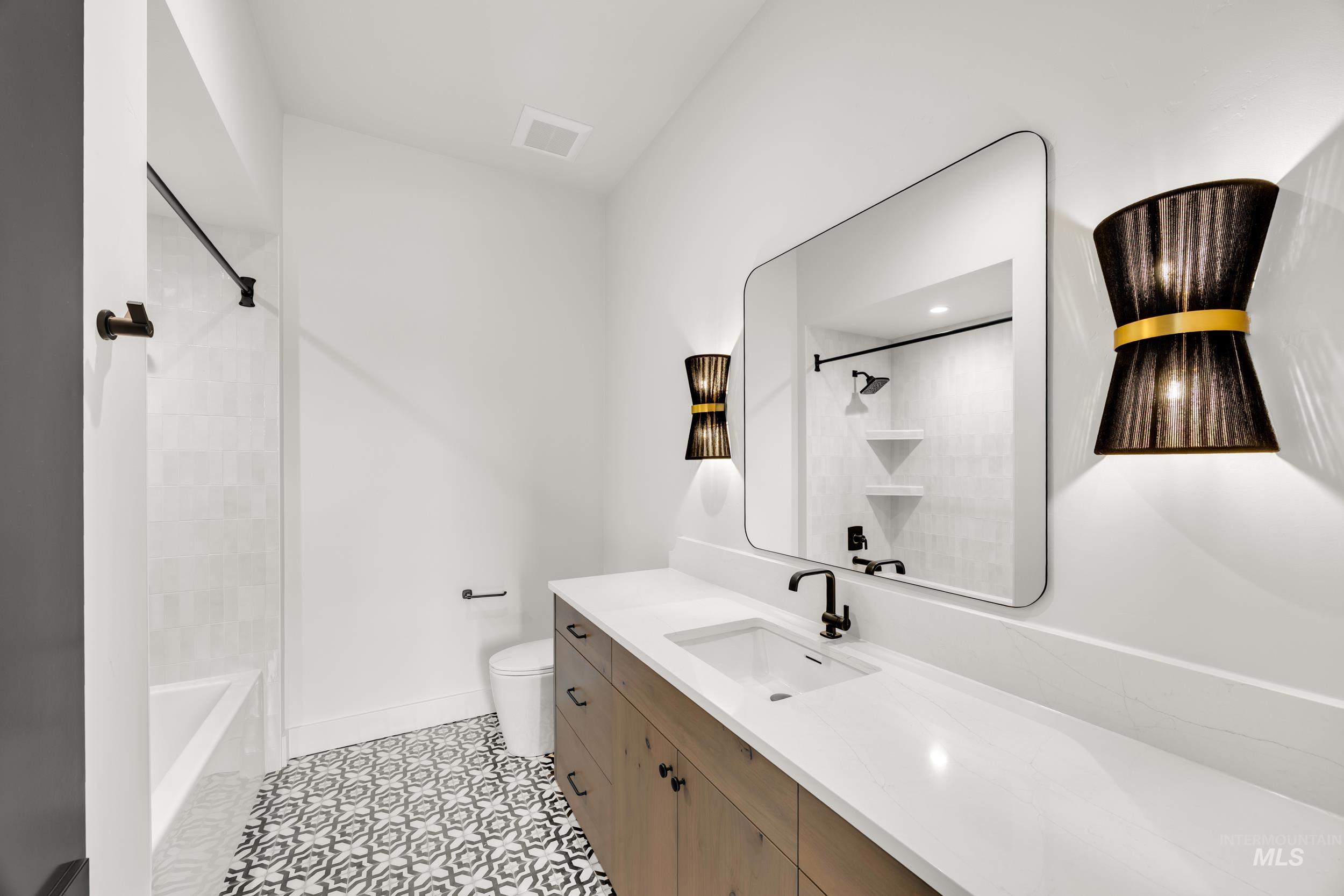 Full bath with vanity, shower / washtub combination, and light tile patterned floors