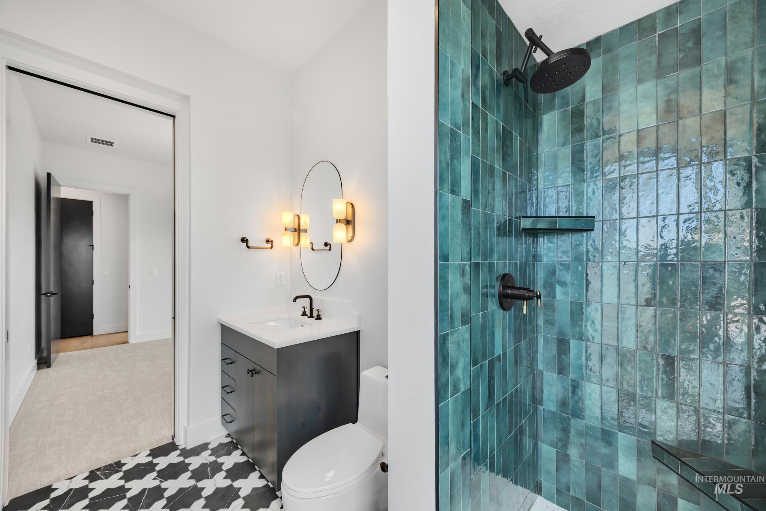 Full bathroom with vanity and a tile shower