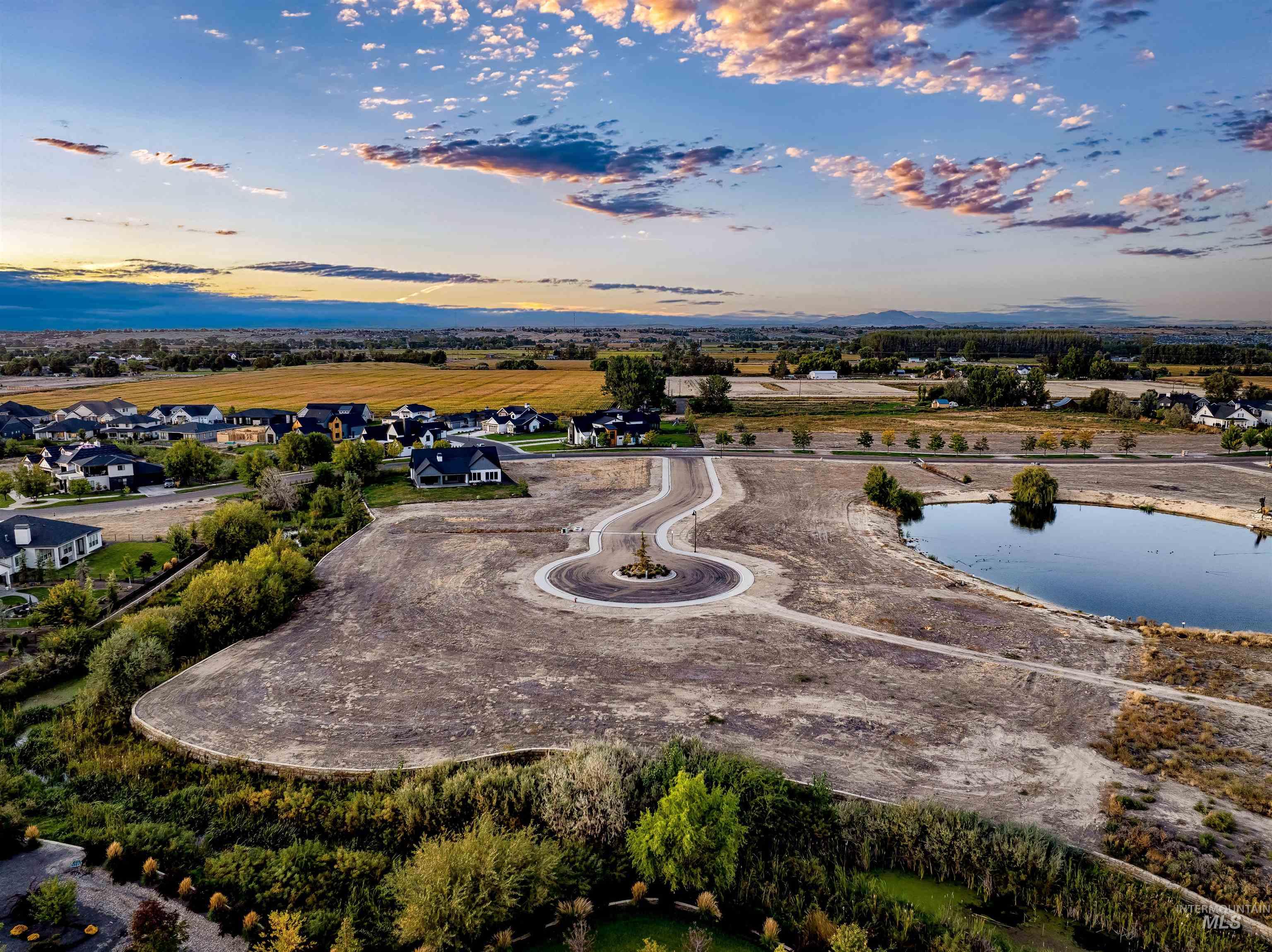 Aerial view at dusk of a water view and a residential view