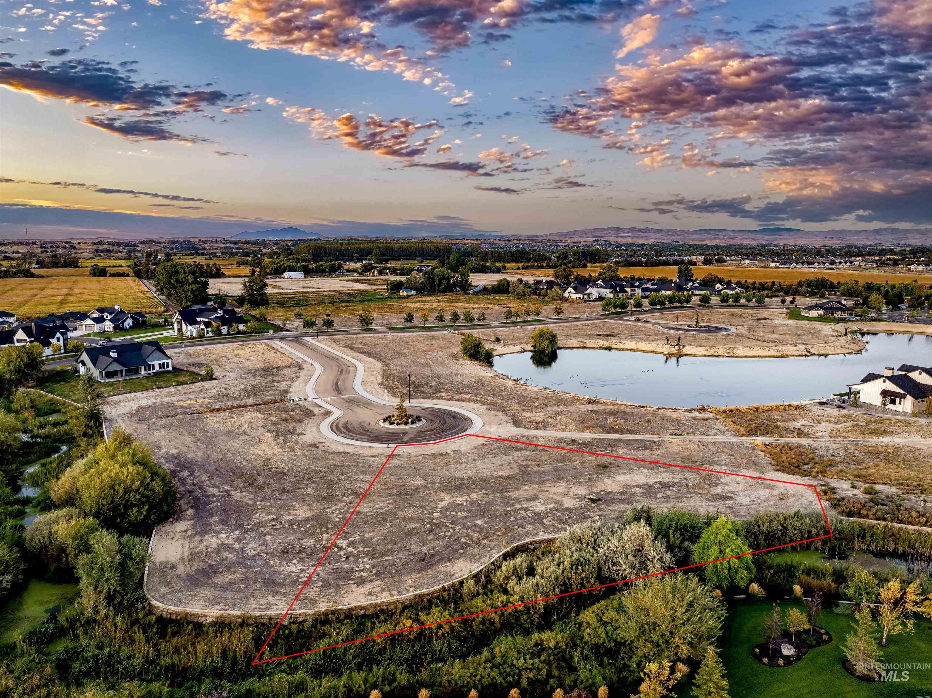 Aerial view at dusk of a water view and property parcel outlined