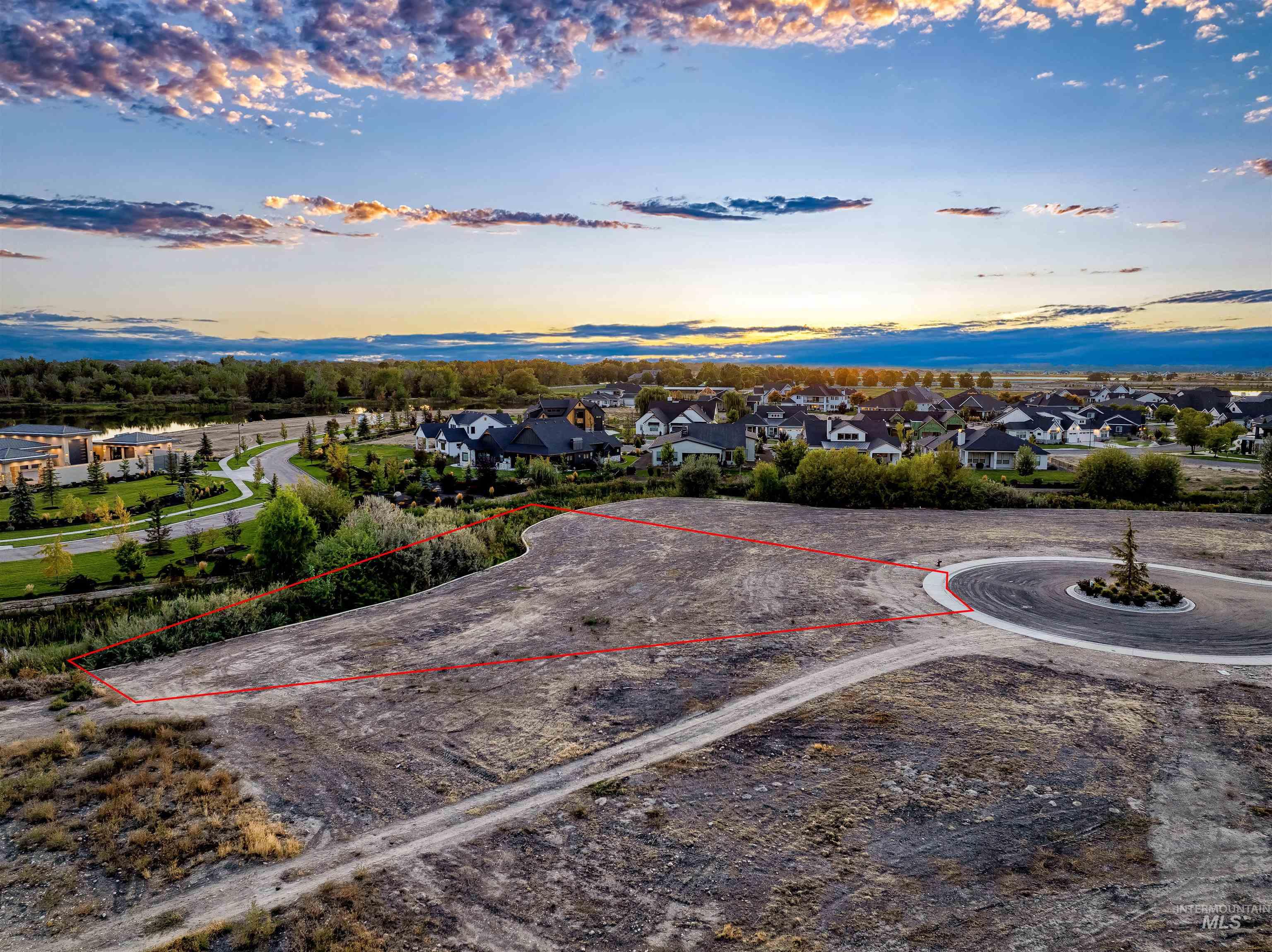 Aerial view at dusk of property boundaries highlighted and a residential view