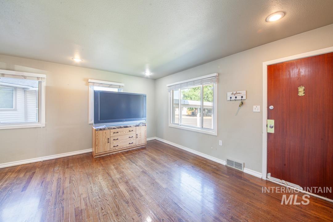 Living room featuring wood finished floors and plenty of natural light