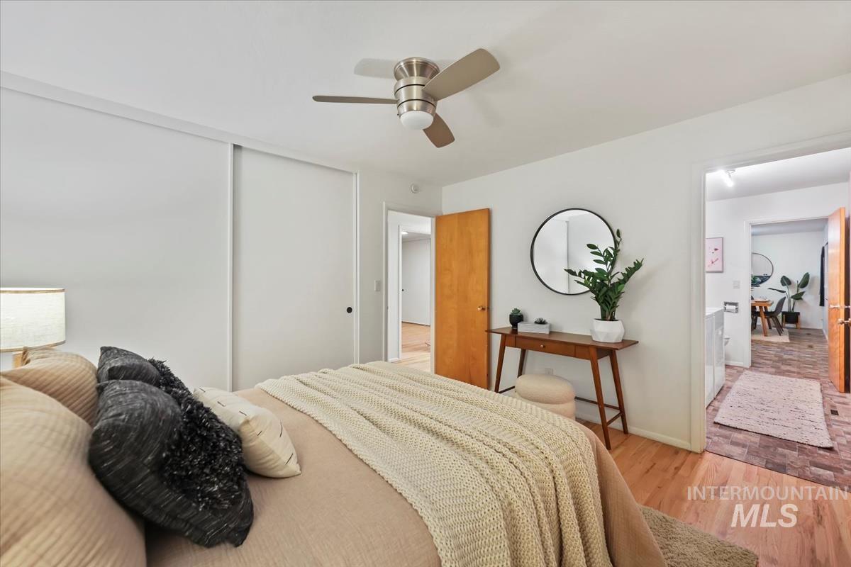 Bedroom with light wood-type flooring, a closet, and a ceiling fan