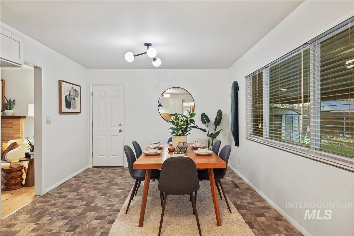 Dining room with stone finish flooring and baseboards