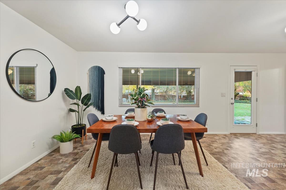 Dining area with baseboards and stone finish flooring