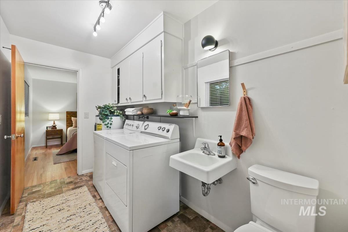 Washroom featuring light stone finish floors and baseboards