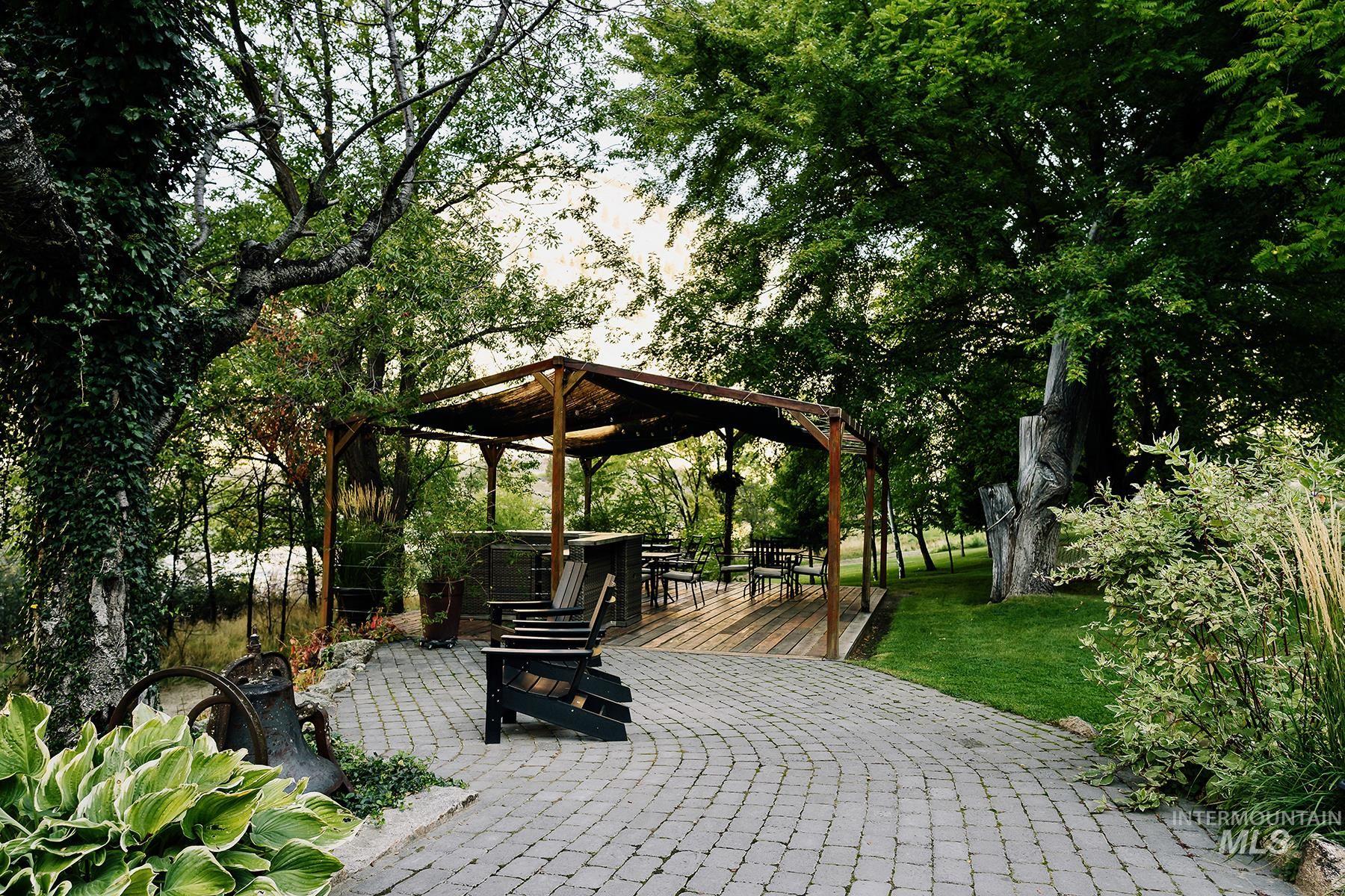 Surrounding community with a patio, a gazebo, and a yard