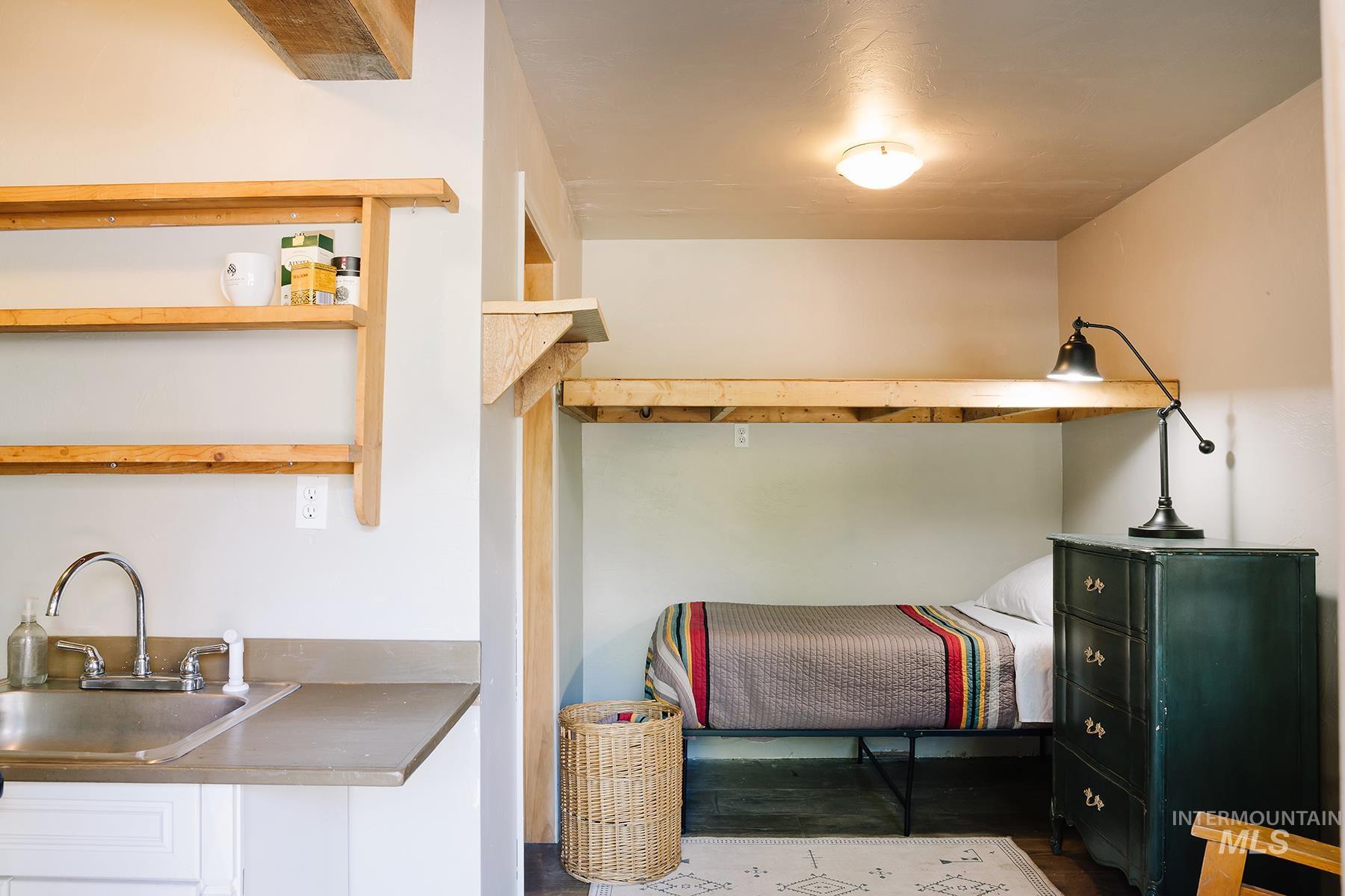 Bedroom with a sink and wood finished floors