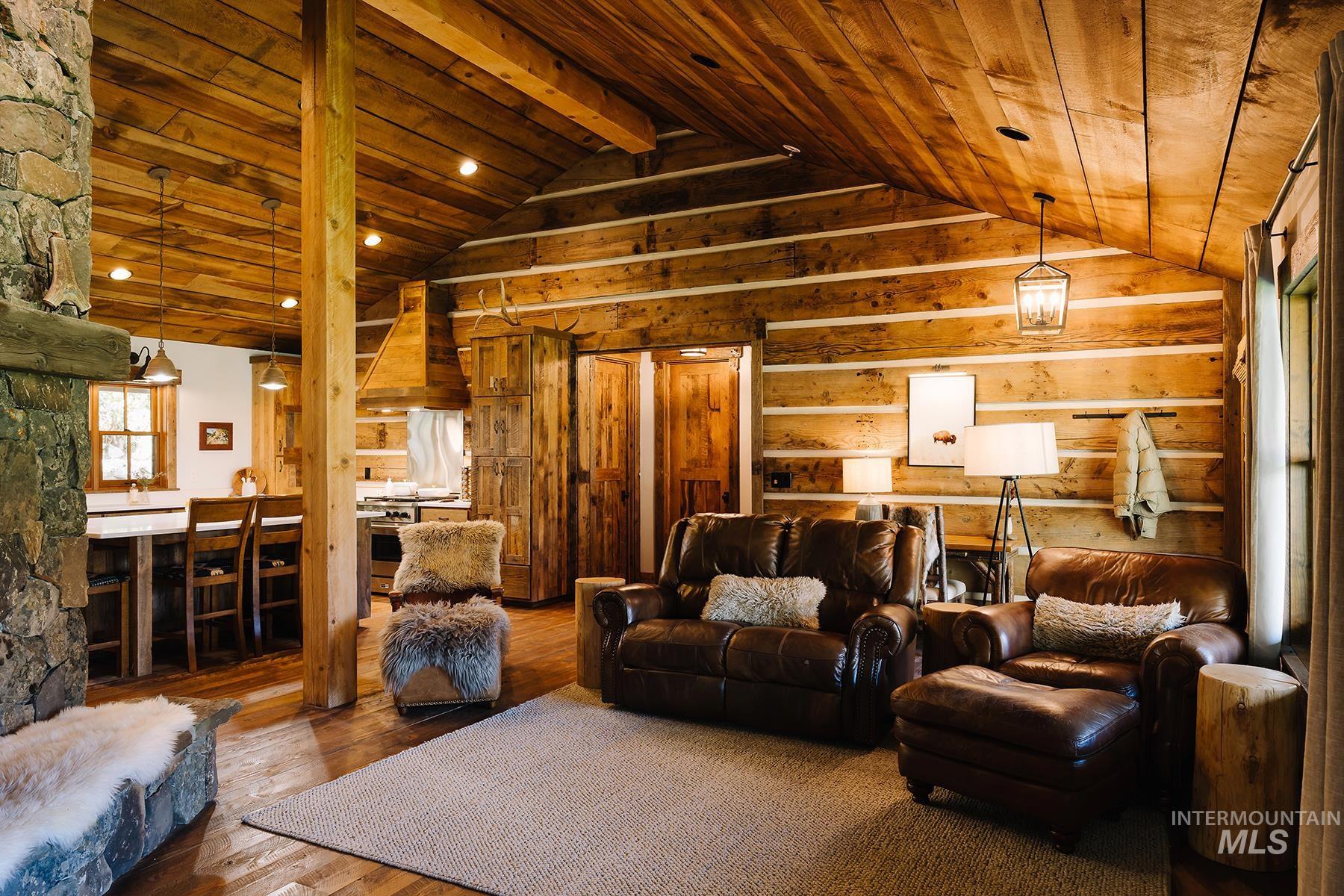 Living area with hardwood / wood-style flooring, wood ceiling, recessed lighting, and wood walls
