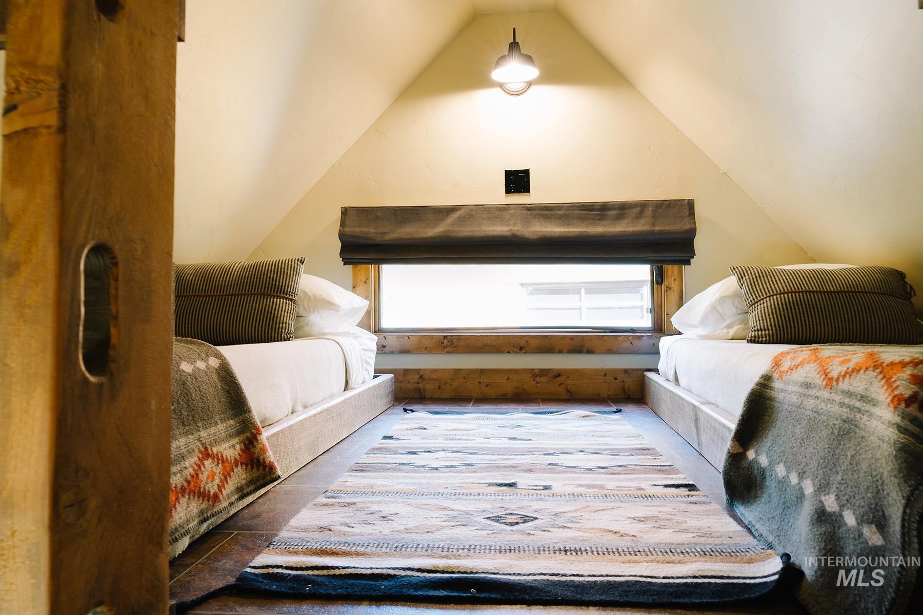 Bedroom featuring lofted ceiling