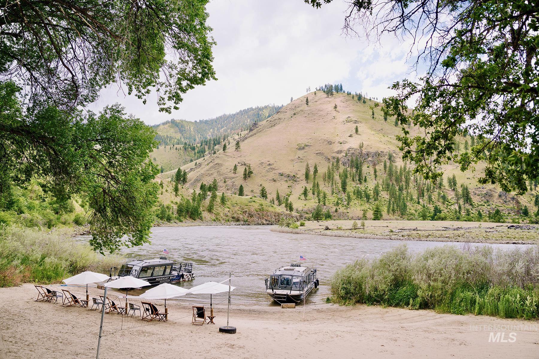 View of property's community featuring a boat dock and a water and mountain view