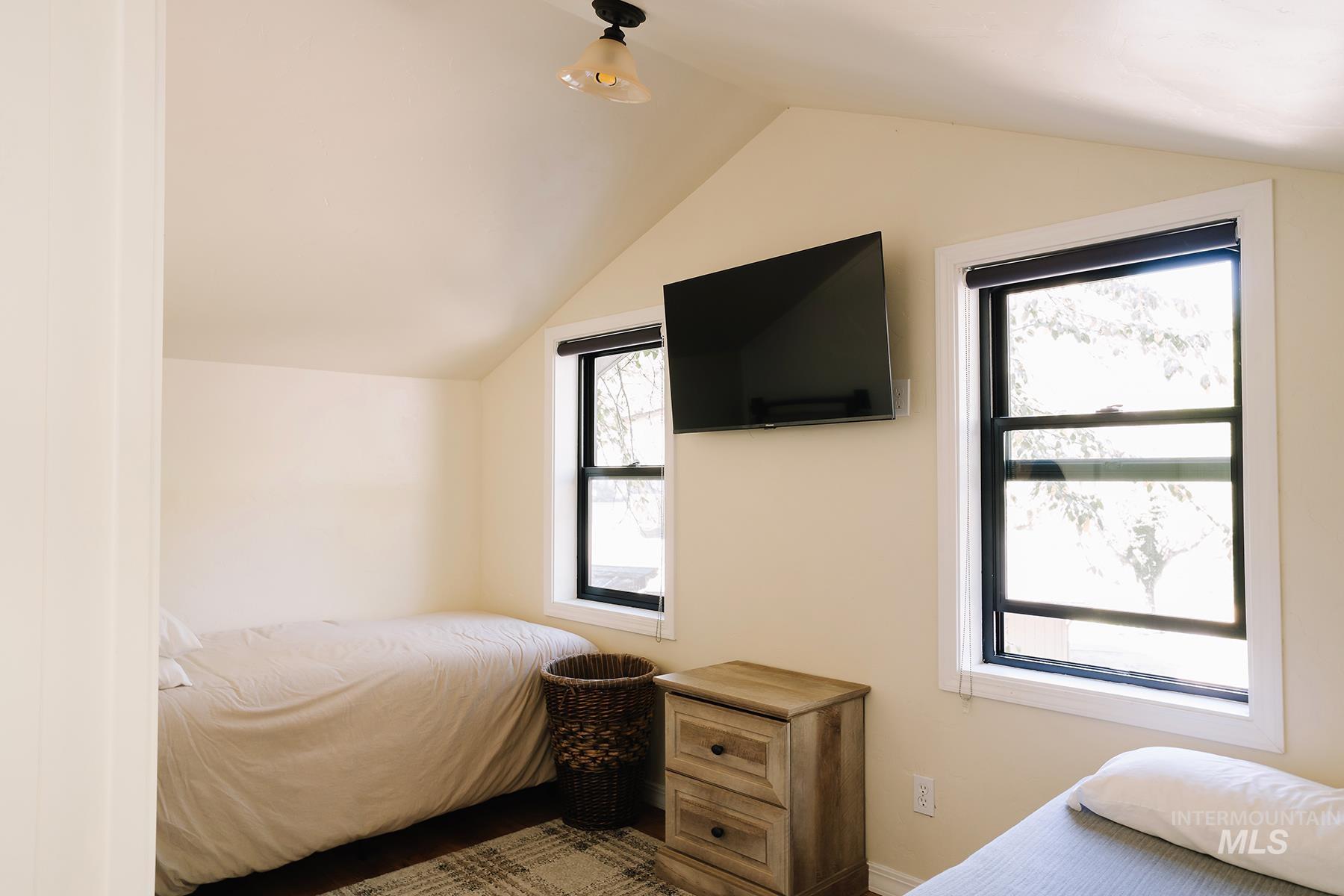 Bedroom with lofted ceiling
