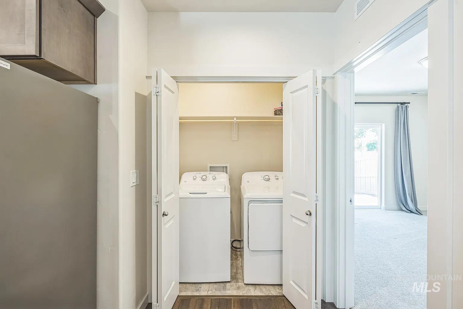 Integrated laundry closet with a top-load washing machine and a front-load dryer