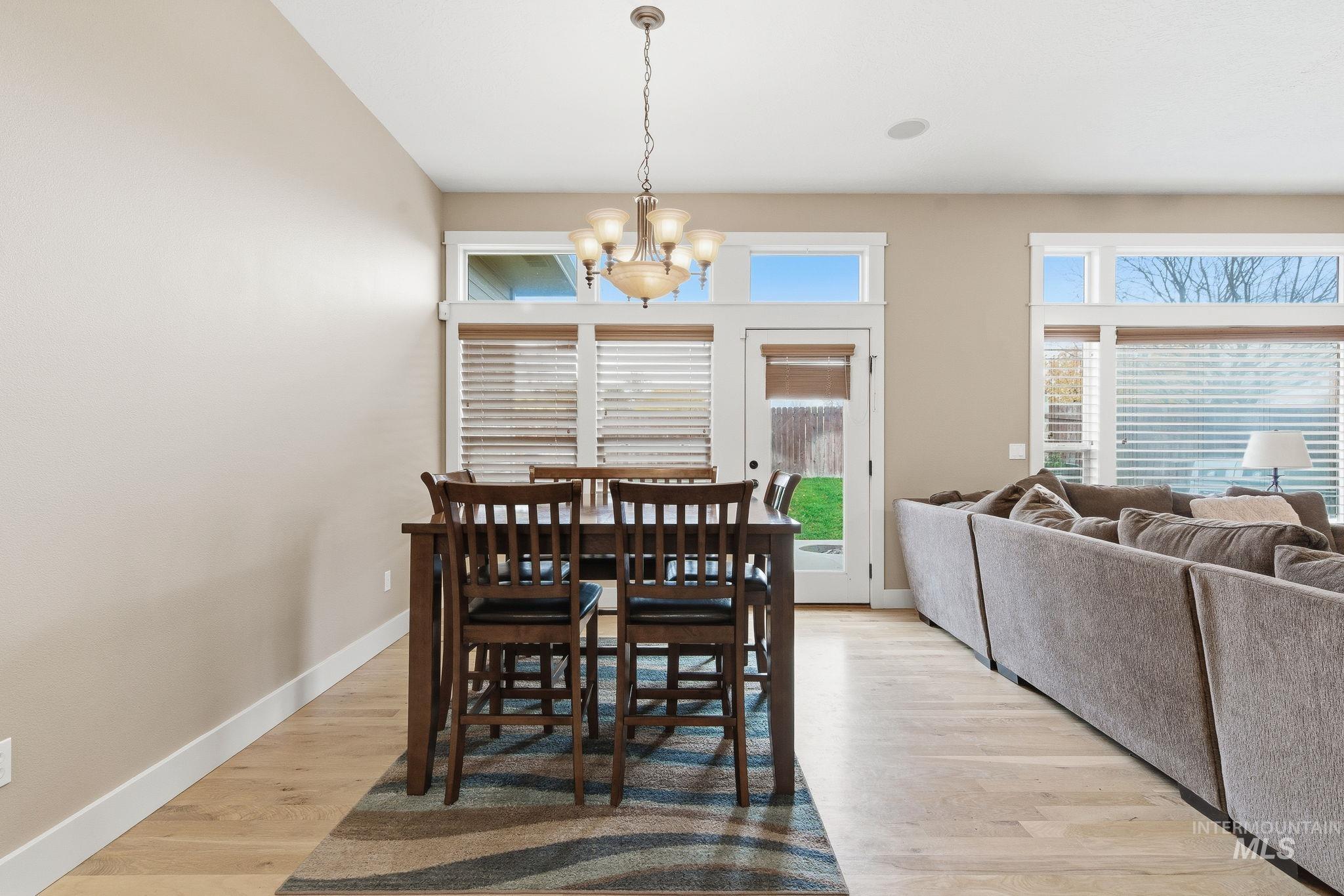 Dining space featuring light wood-style flooring and a chandelier