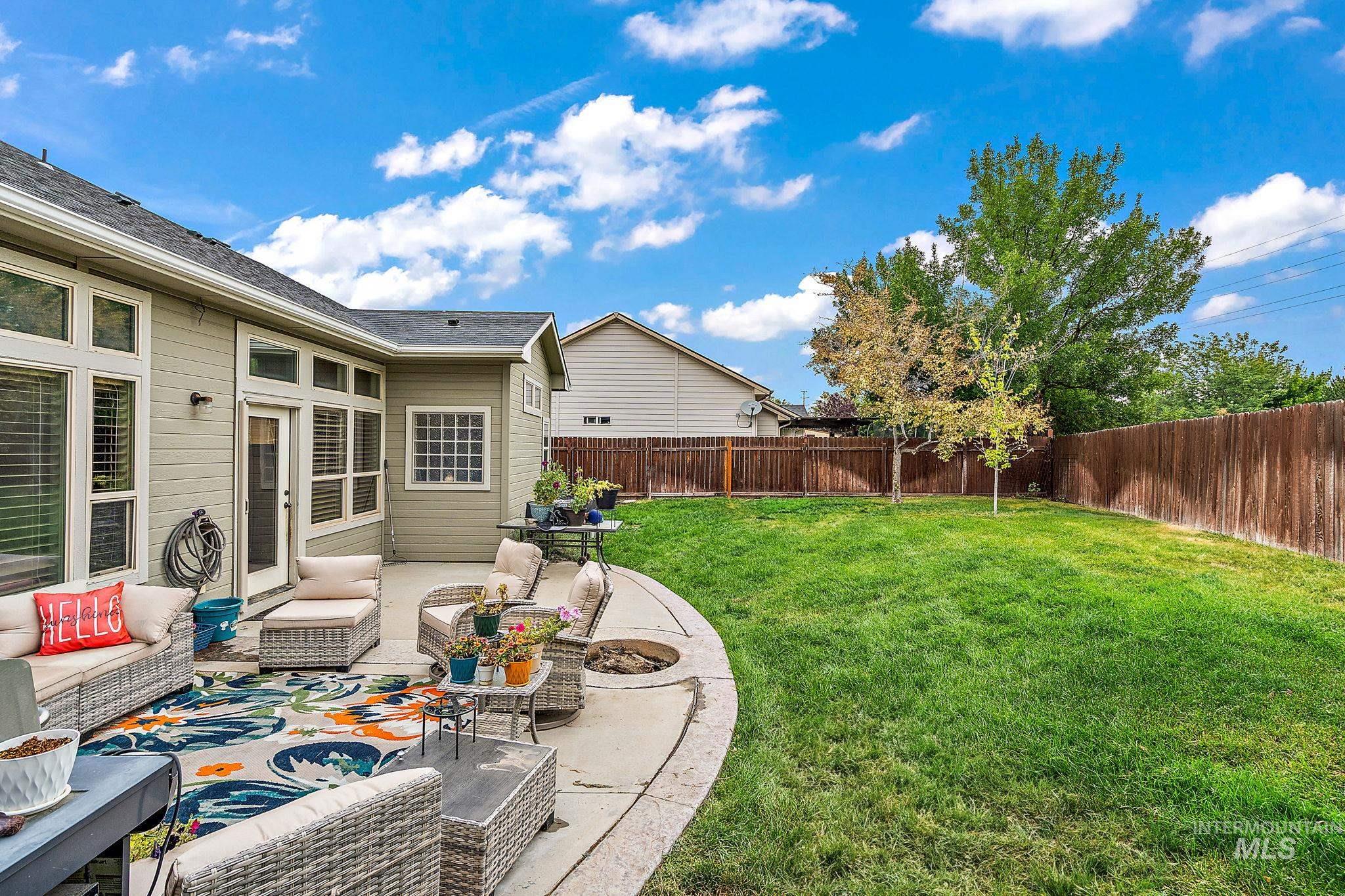 Fenced backyard with a patio and an outdoor hangout area