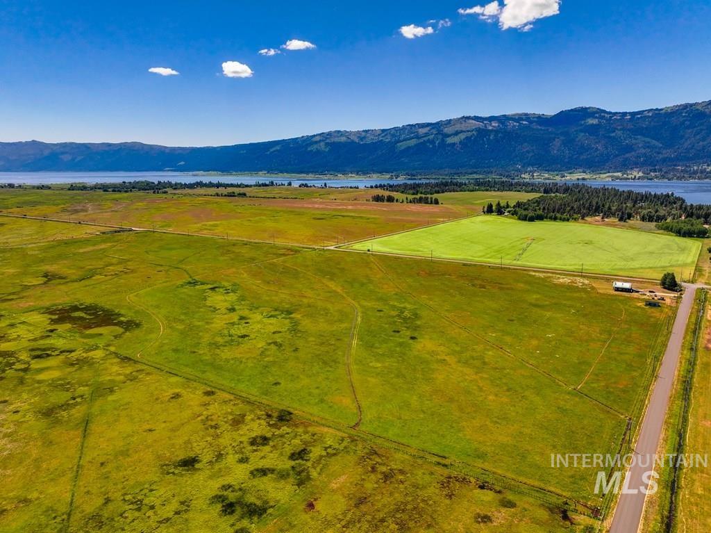 View of rural area featuring a water and mountain view and agricultural land