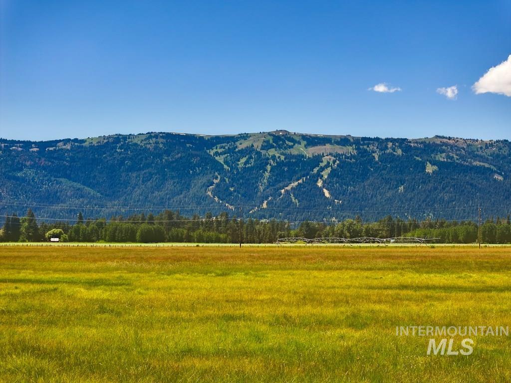 View of mountain backdrop with rural landscape