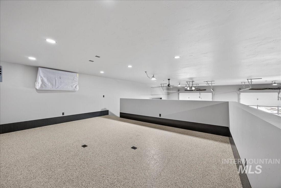 Miscellaneous room featuring dark speckled floor and recessed lighting
