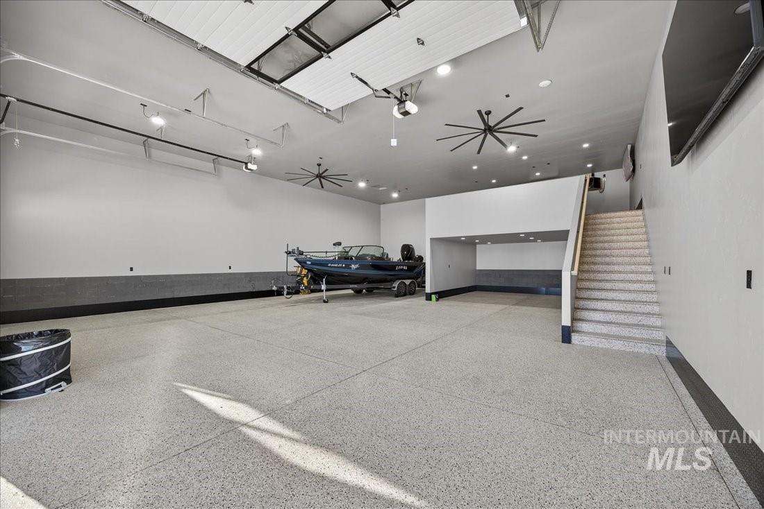 Misc room with a garage and stairs