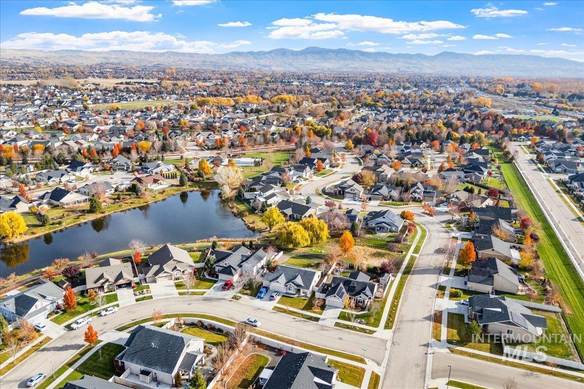 Aerial overview of property's location featuring nearby suburban area and a water and mountain view