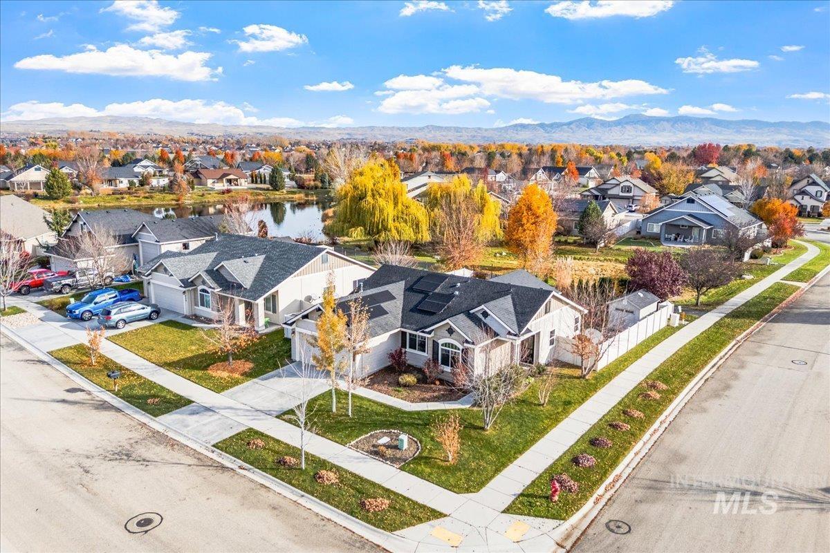 Aerial perspective of suburban area featuring a large body of water