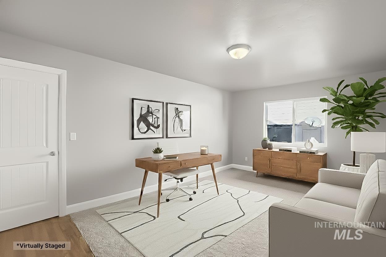 Office space featuring baseboards and light wood finished floors