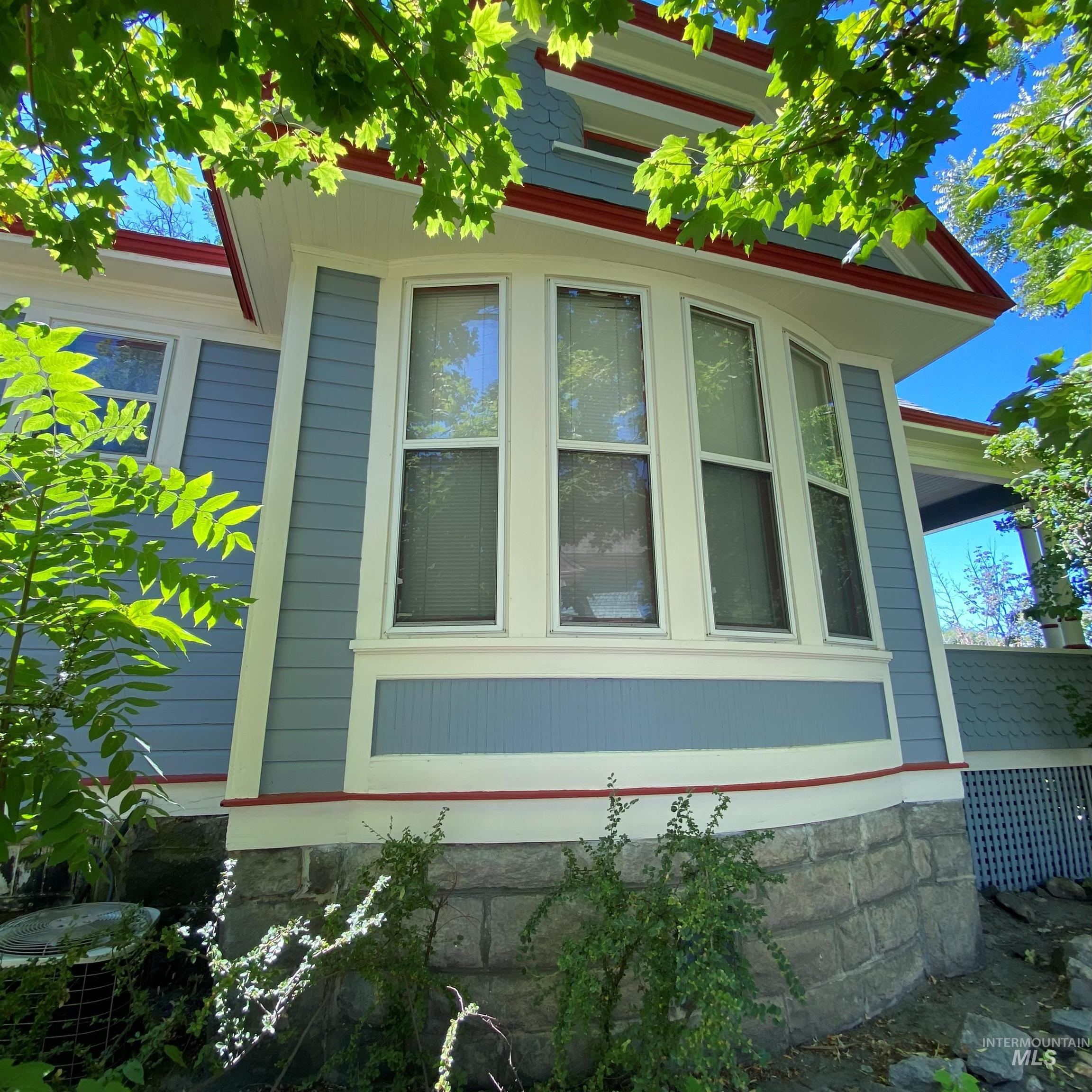 View of side of home featuring a cooling unit