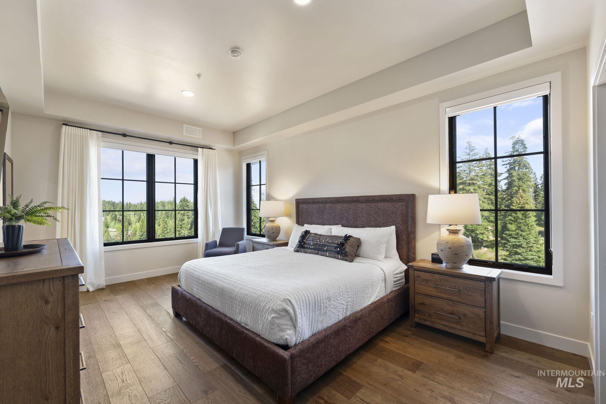 Bedroom with hardwood / wood-style floors and recessed lighting