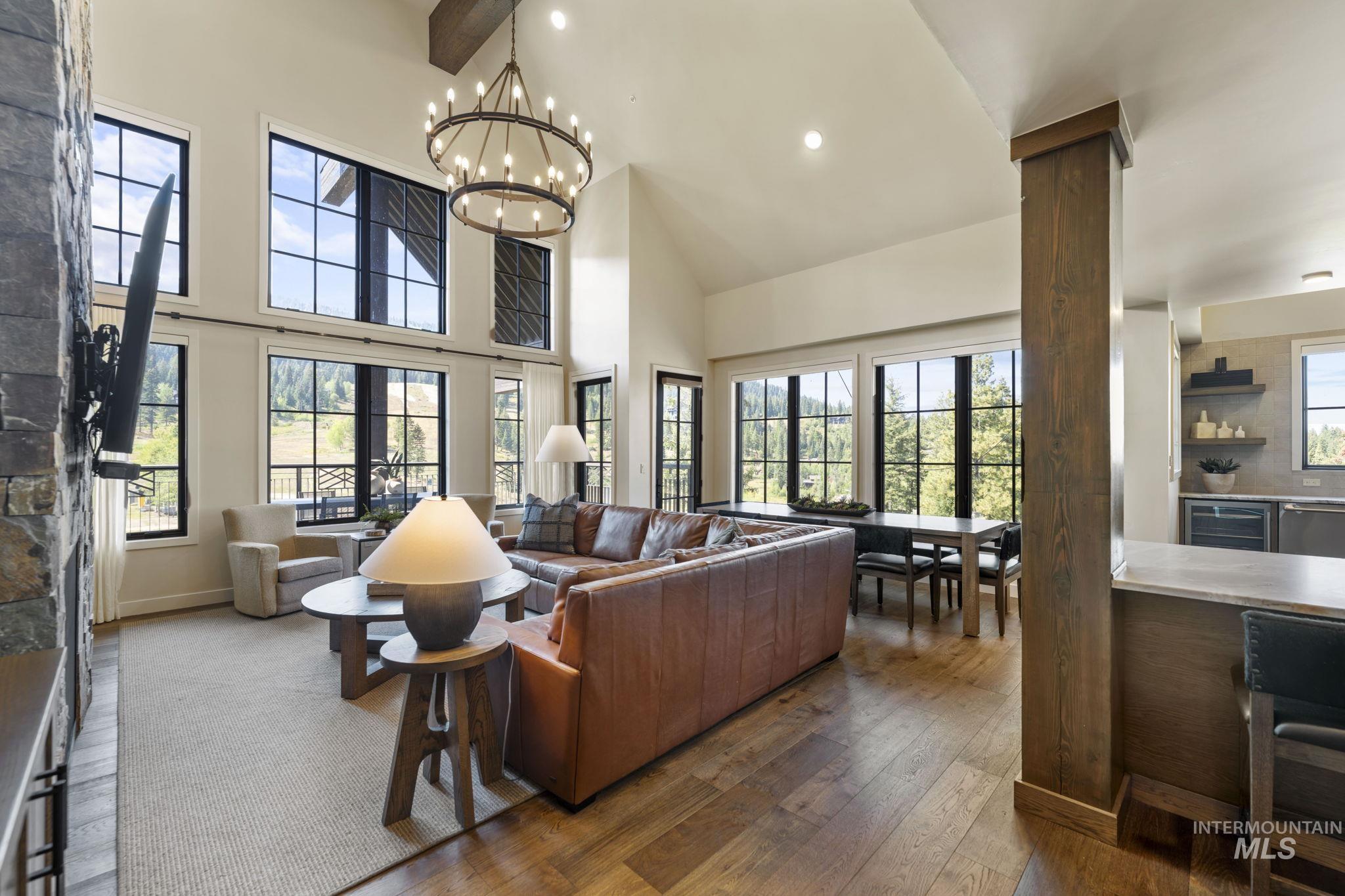 Living area featuring dark wood-type flooring, recessed lighting, wine cooler, high vaulted ceiling, and beamed ceiling