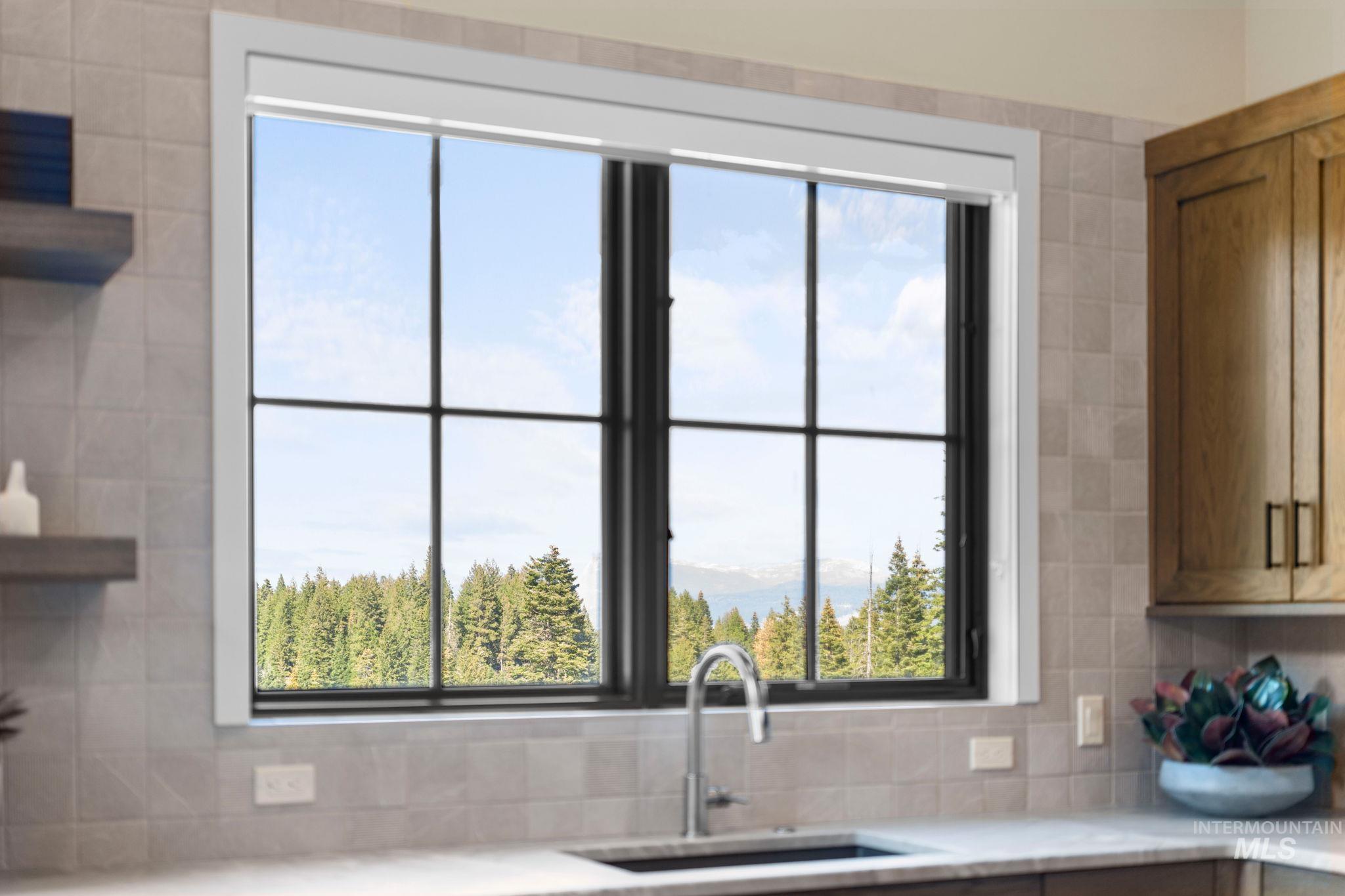 Kitchen with plenty of natural light, decorative backsplash, light stone countertops, and open shelves