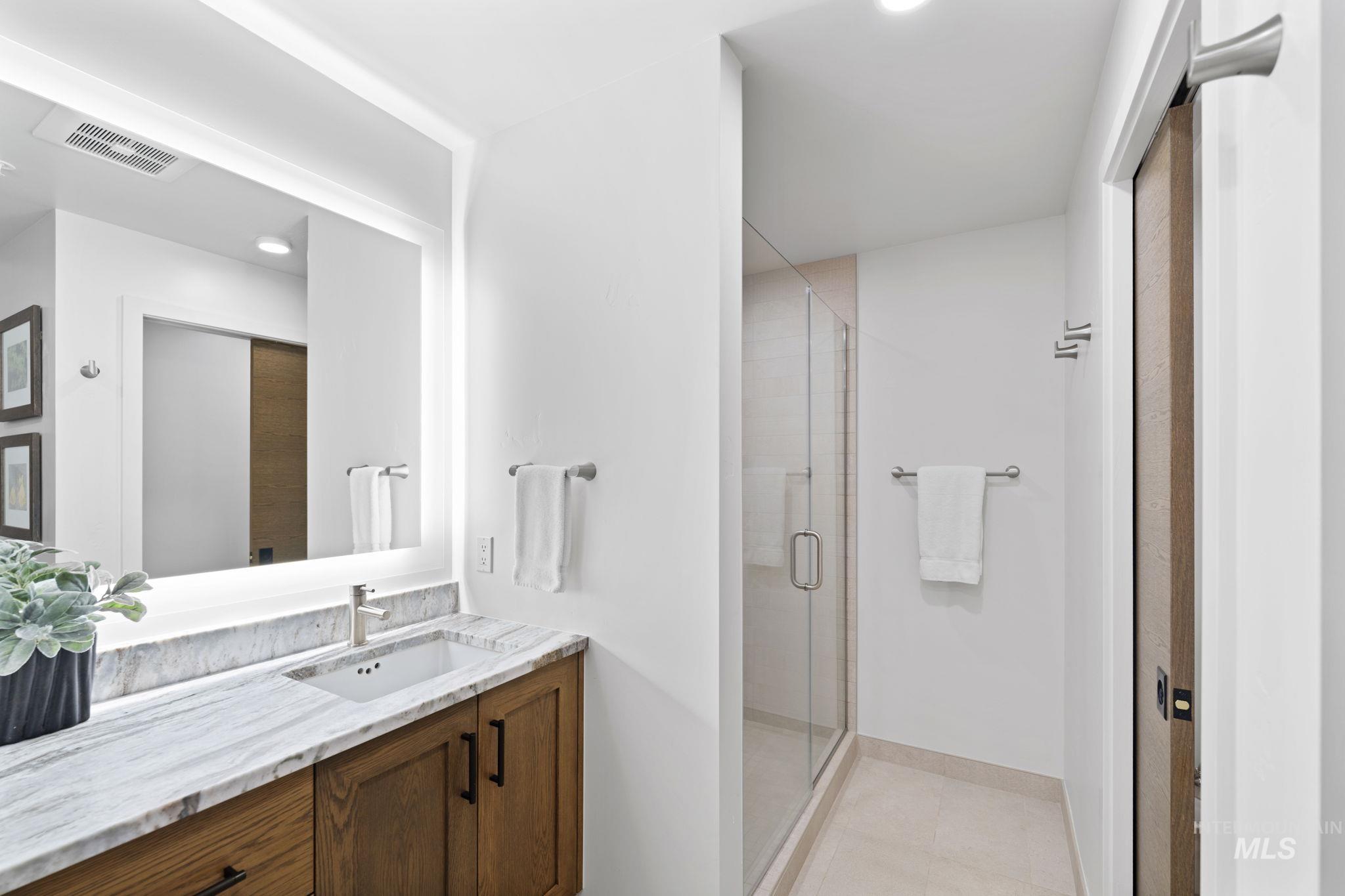 Full bath with vanity, a shower stall, light tile patterned floors, and recessed lighting