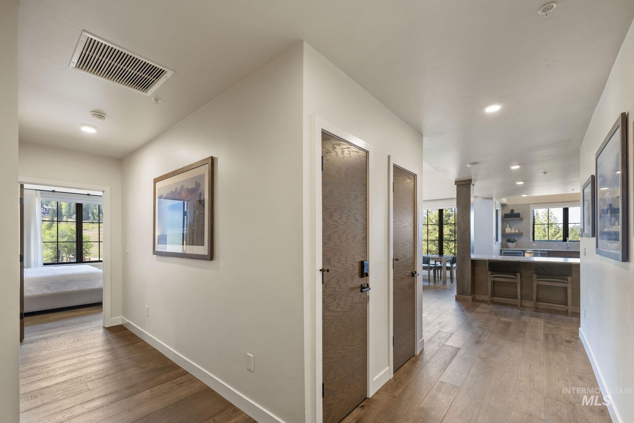 Hallway featuring light wood-style flooring and recessed lighting
