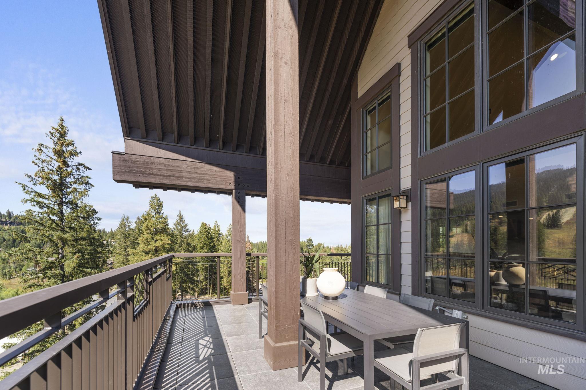 Balcony with outdoor dining space and a sunroom