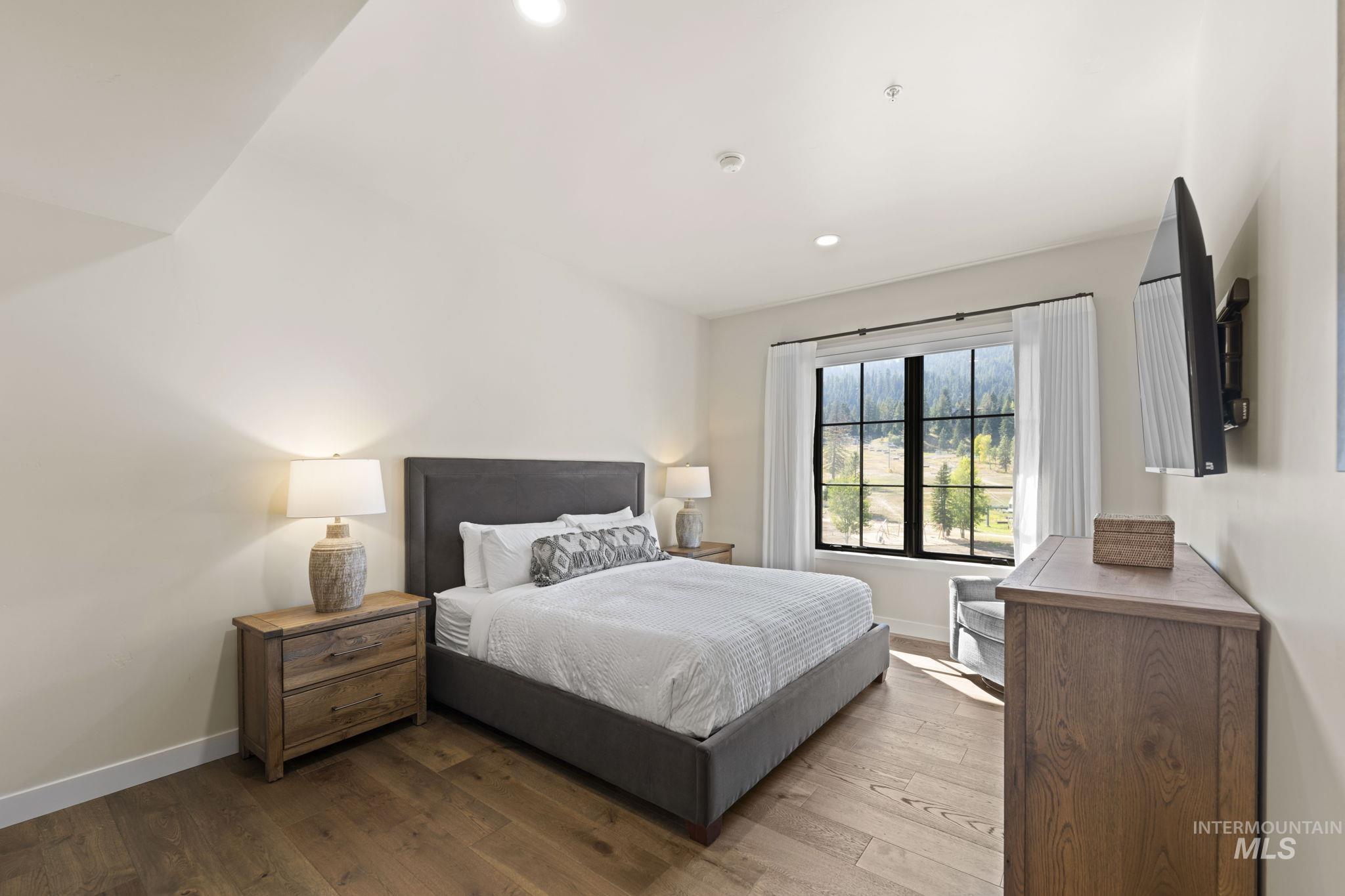 Bedroom with hardwood / wood-style flooring and recessed lighting