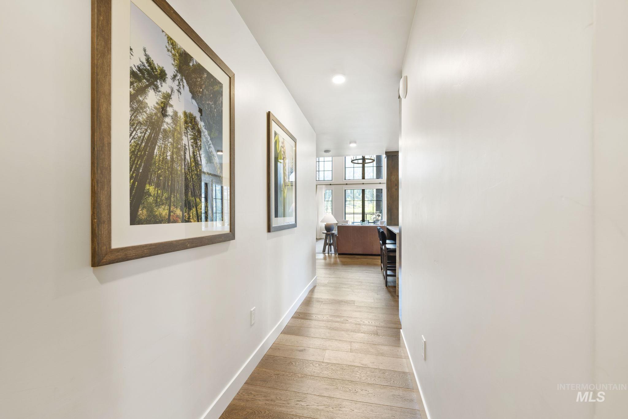 Hall featuring light wood-type flooring and recessed lighting