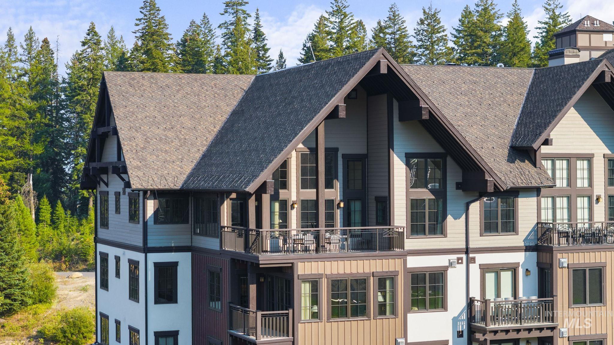 Back of property with a balcony and board and batten siding