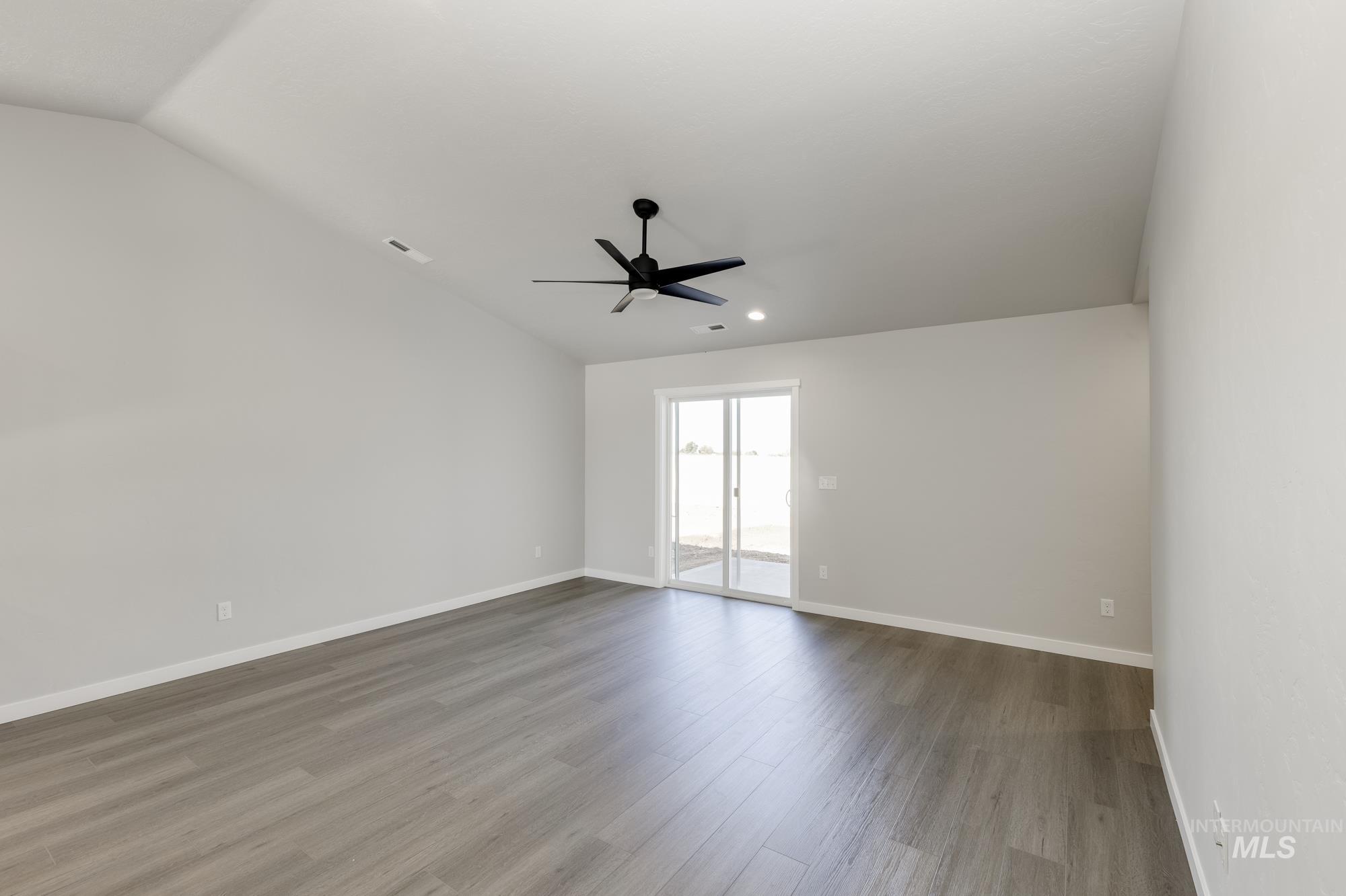 Empty room featuring light wood-style floors, lofted ceiling, recessed lighting, and ceiling fan
