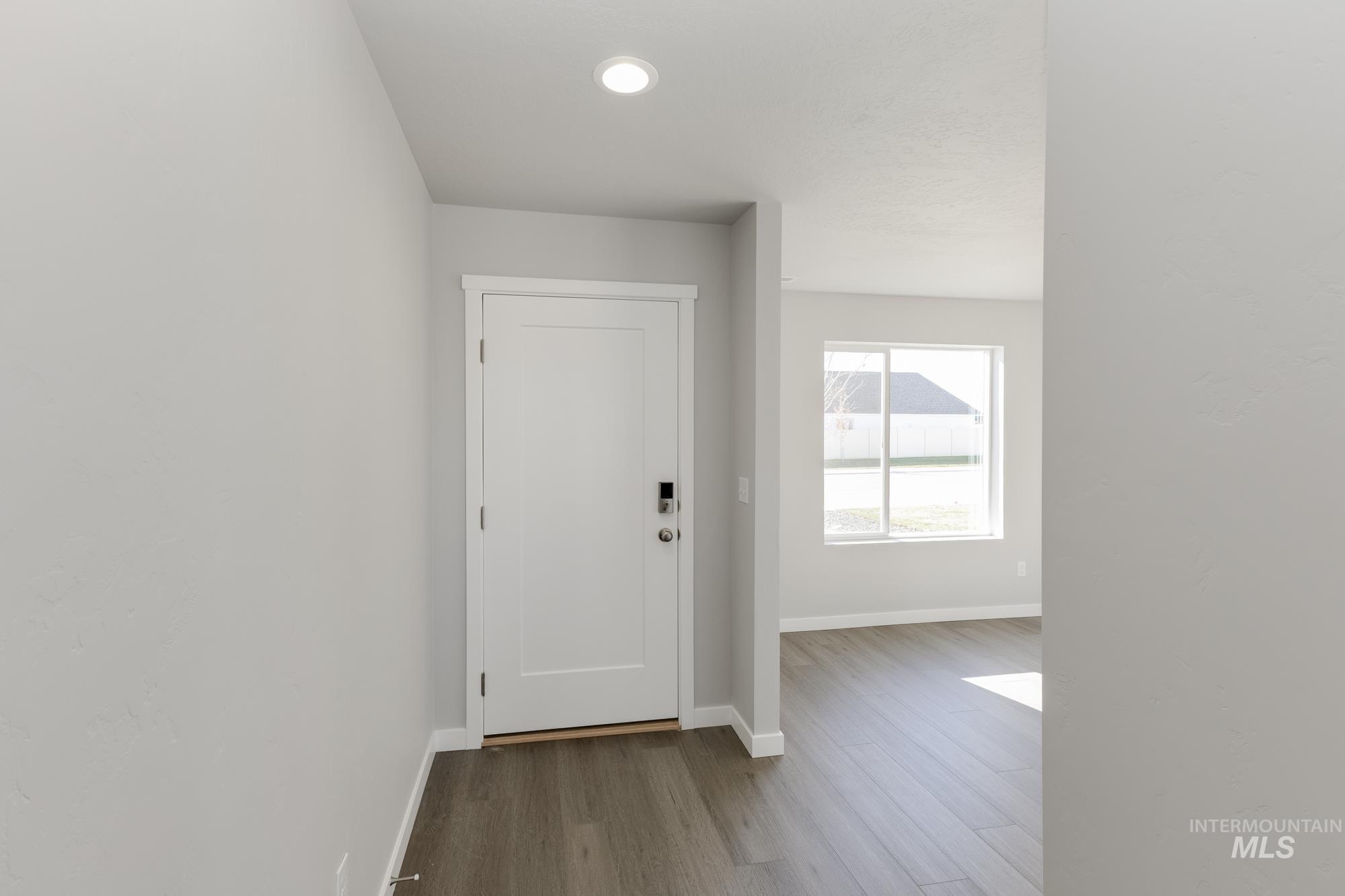 Foyer entrance featuring baseboards and wood finished floors