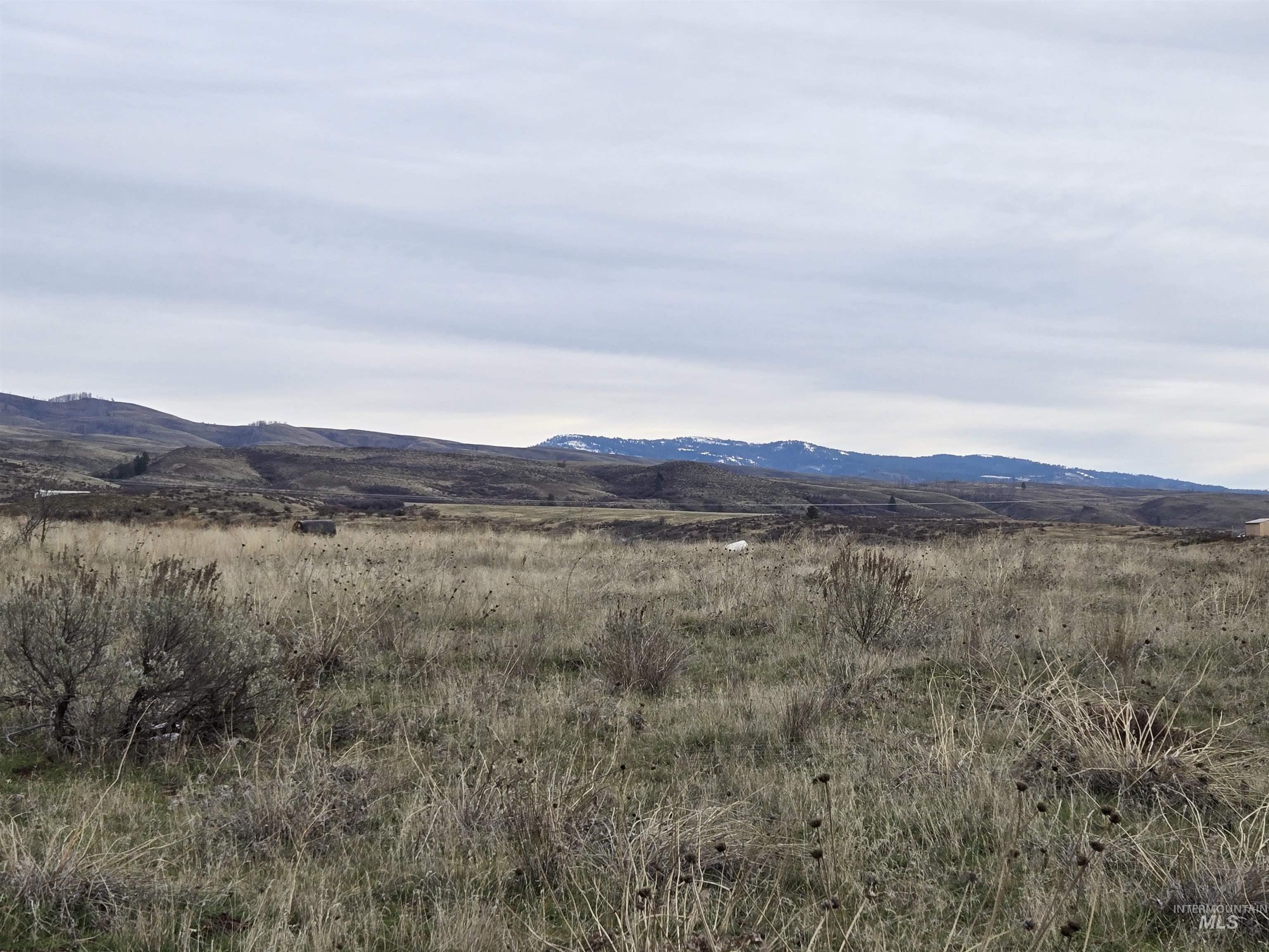 View of mountain backdrop with rural landscape