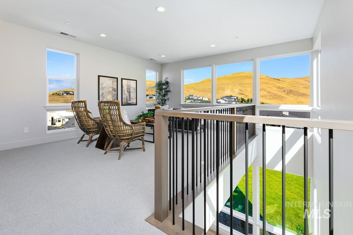Interior space with light carpet, recessed lighting, and a mountain view