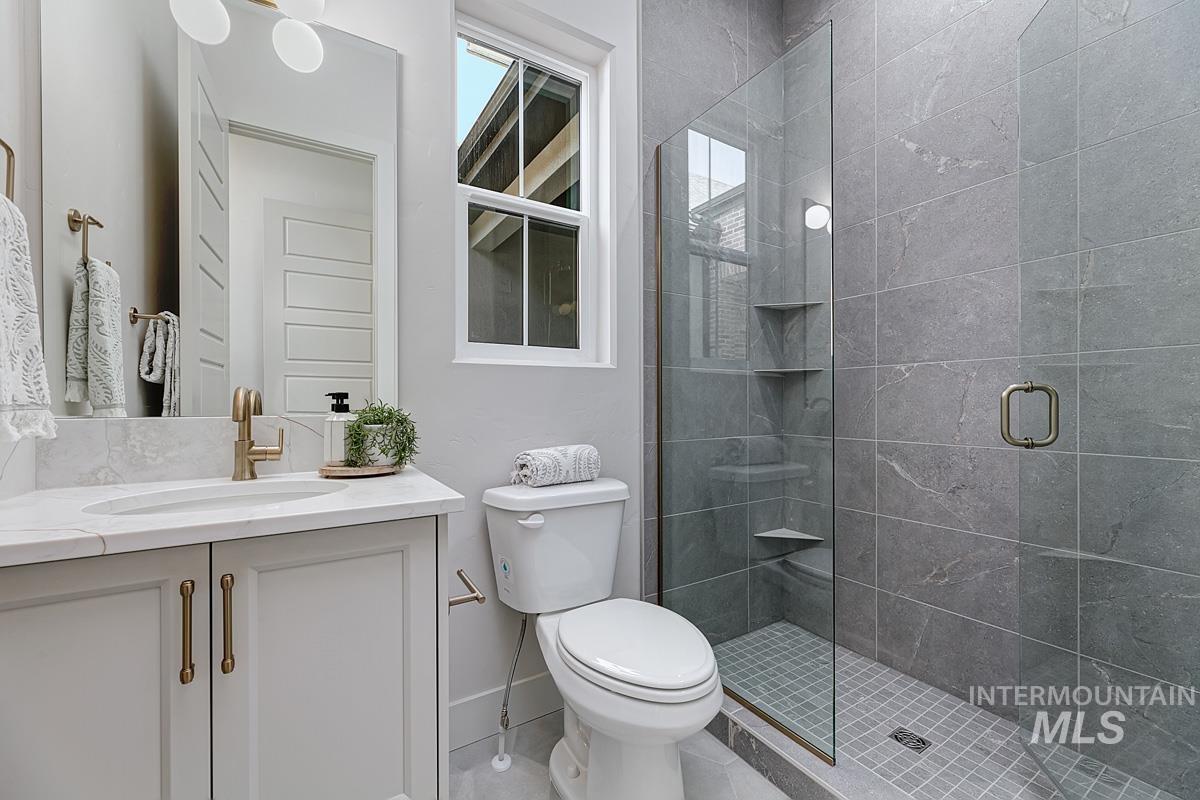 Bathroom with a stall shower, vanity, and light tile patterned floors