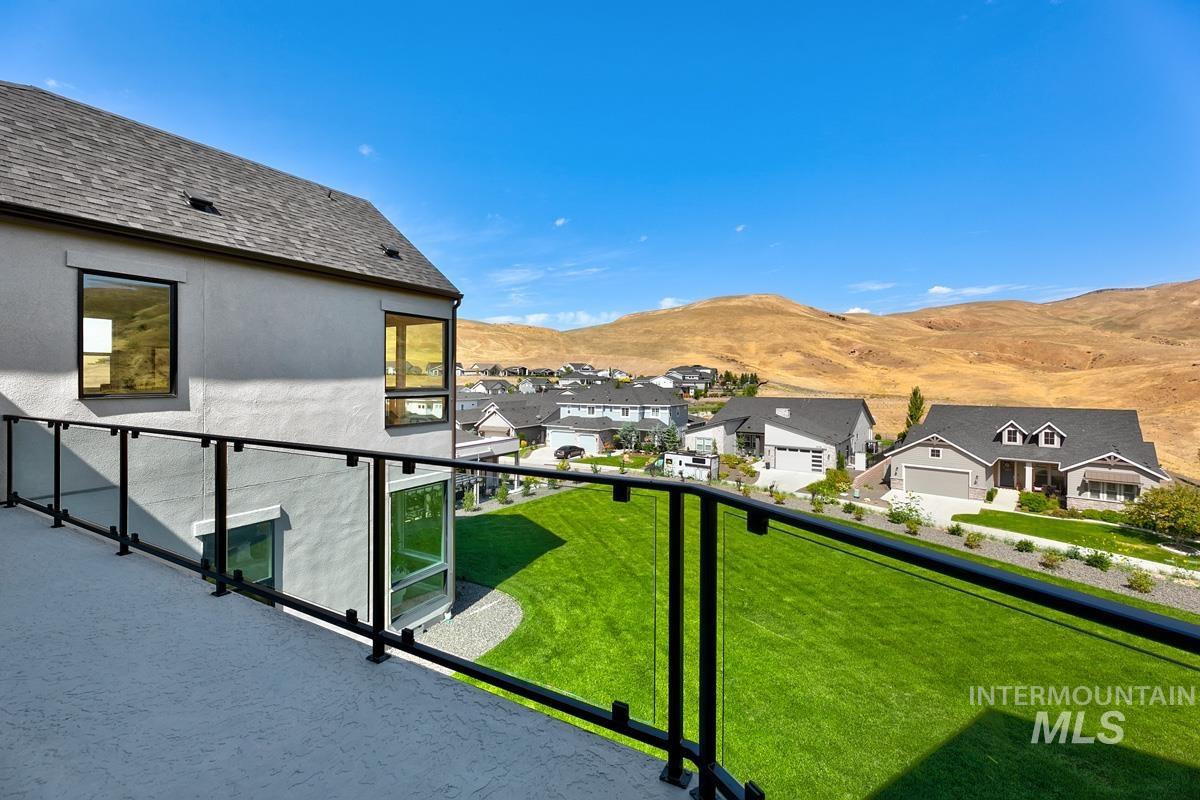 Balcony featuring a mountain view and a residential view