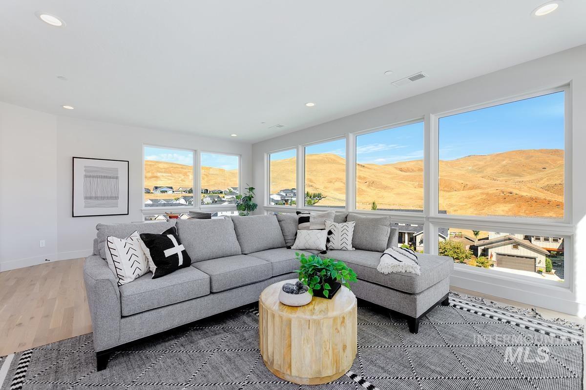 Living area with a mountain view, recessed lighting, and wood finished floors