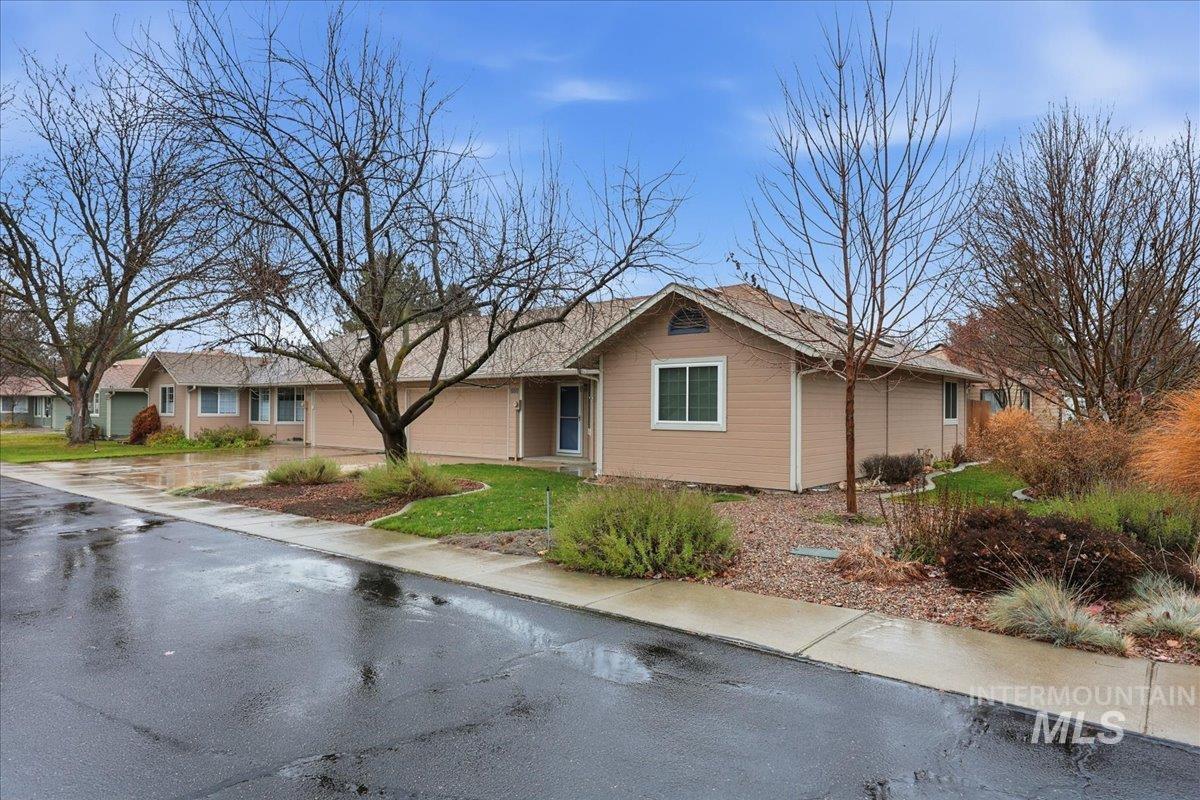 Ranch-style home featuring an attached garage and a front lawn