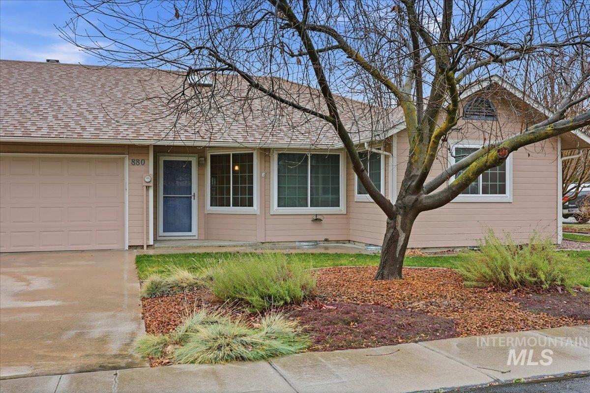 View of front of house featuring roof with shingles, a garage, and concrete driveway