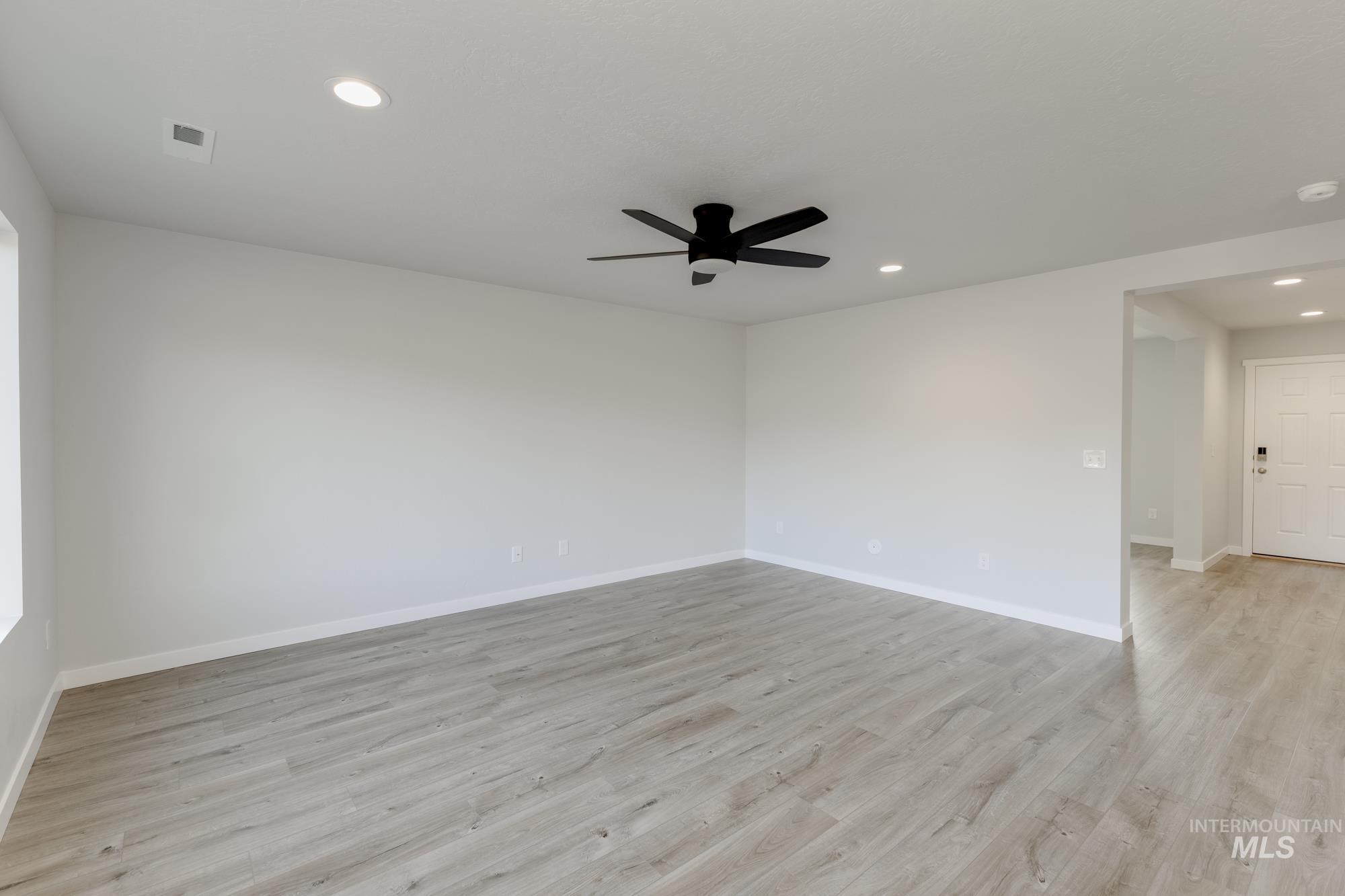 Unfurnished room with light wood-type flooring, recessed lighting, and a ceiling fan