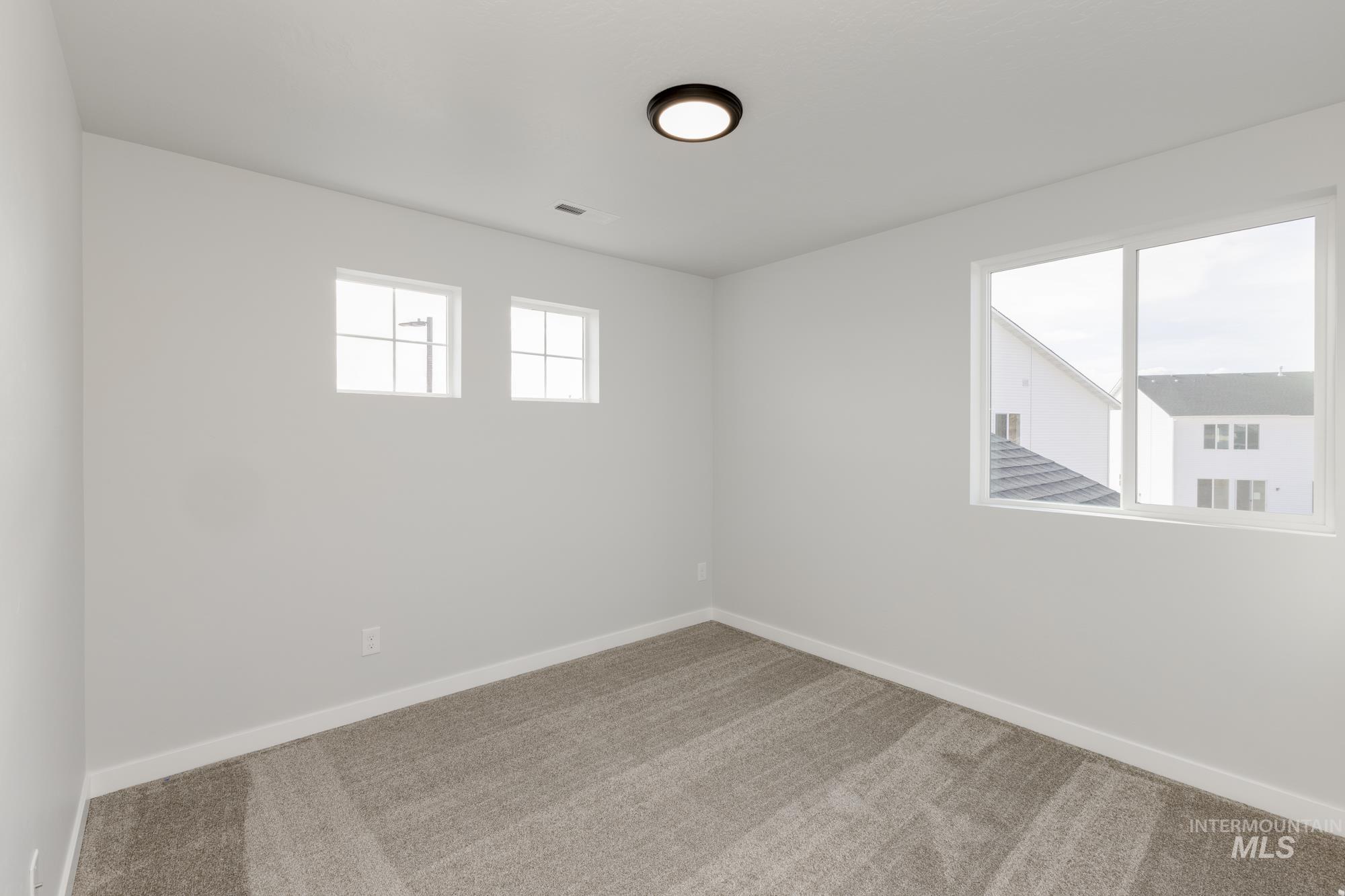 Empty room with baseboards and carpet