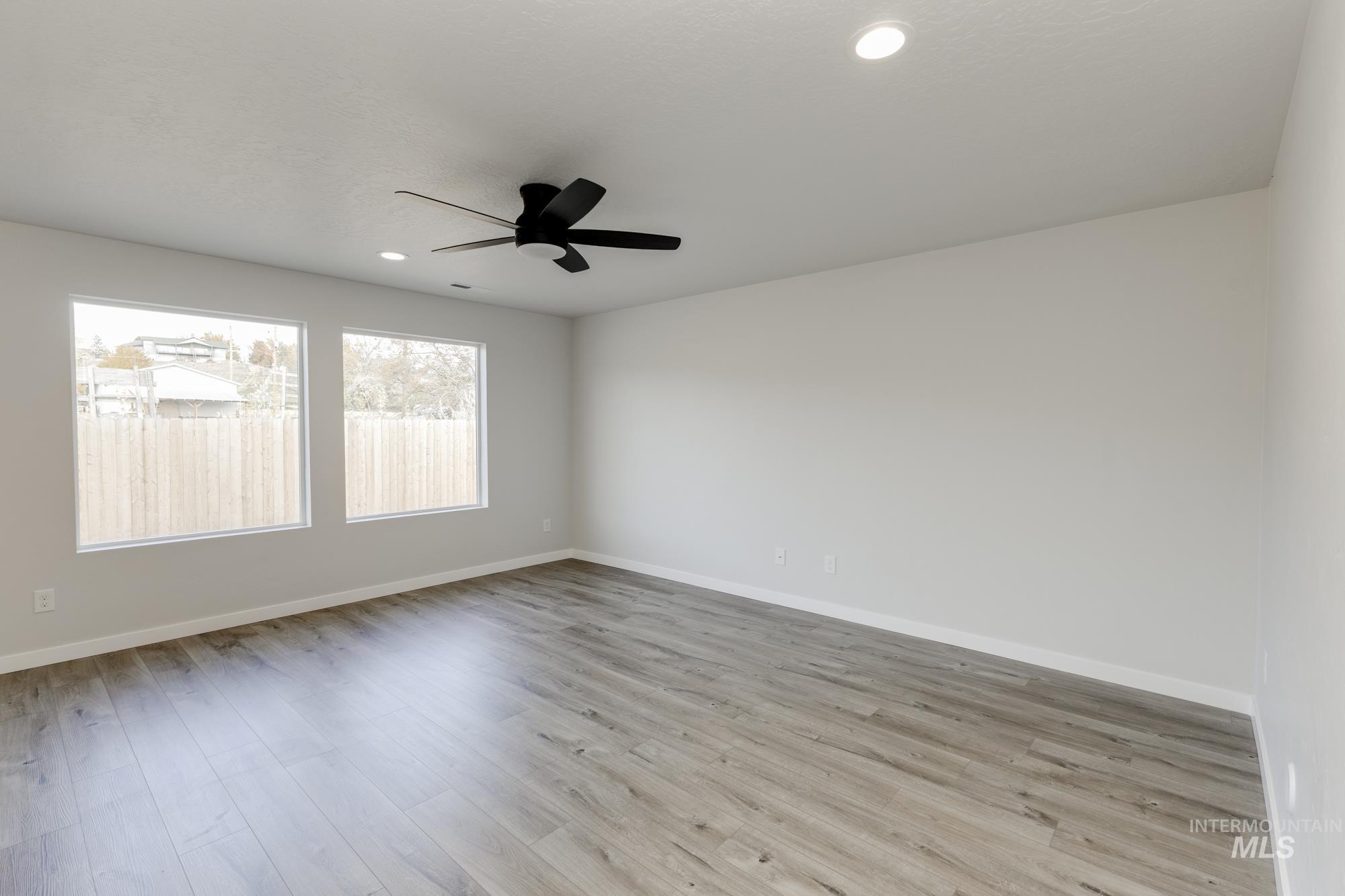 Unfurnished room with light wood-type flooring, recessed lighting, and ceiling fan