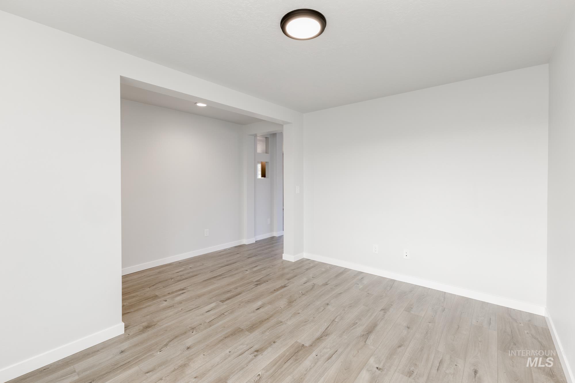 Spare room with light wood-style floors and recessed lighting