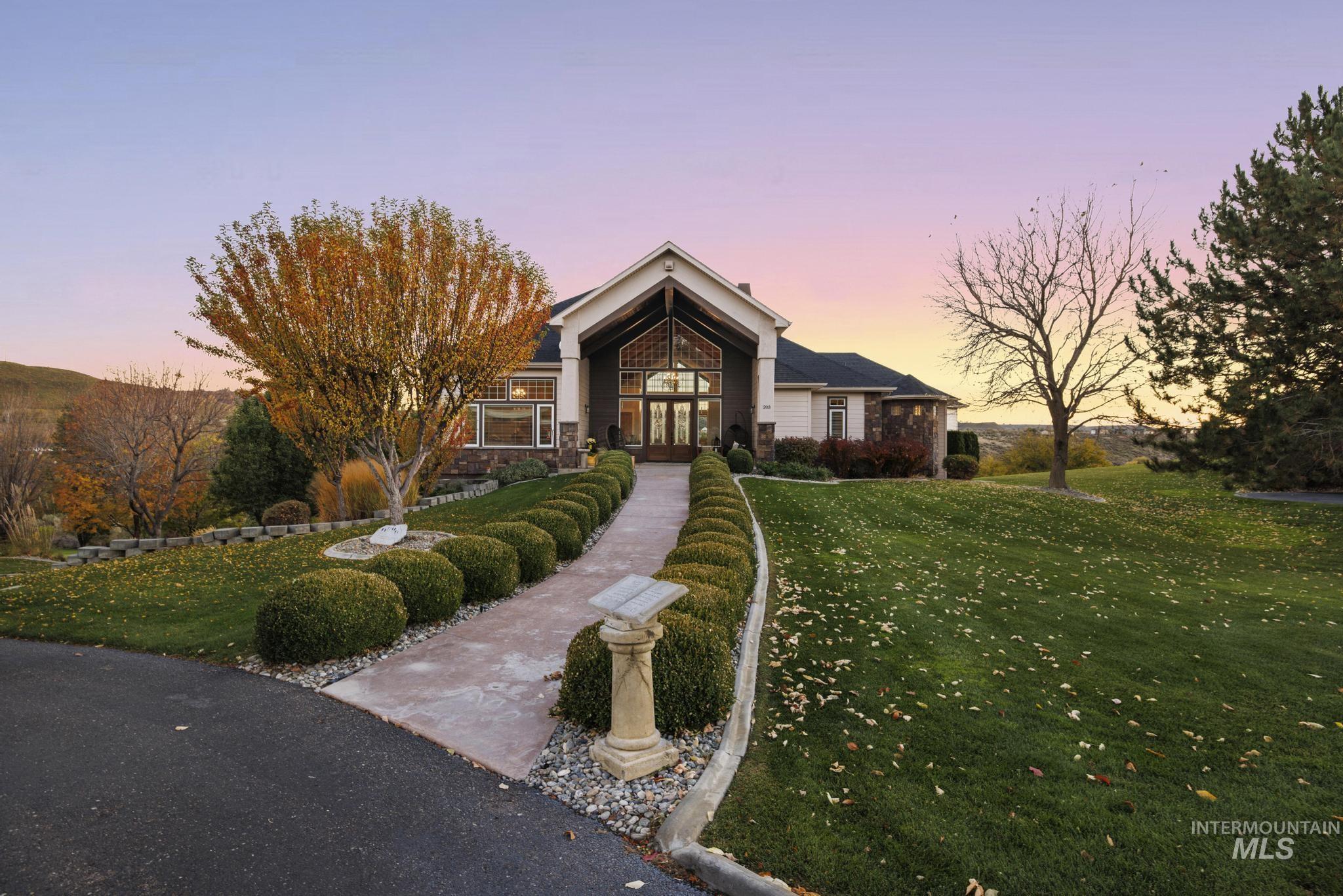 View of front of property with a lawn, french doors, and stone siding